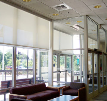 This Is A Picture Of A Lobby With Solar Shades On The Windows.