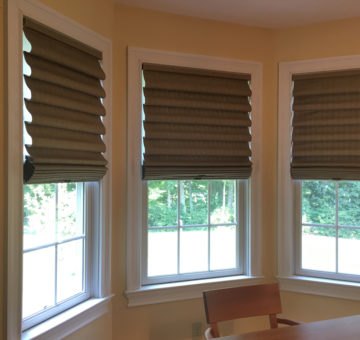 This Is A Picture Of Three Windows Which Have Cordless Roman Shades On Them.